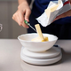 Person measuring butter on cooking scale